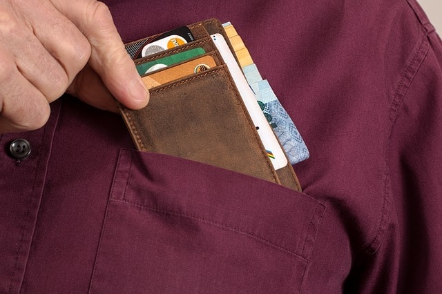 putting wallet with business cards in shirt pocket