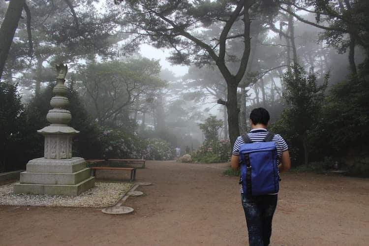 man walking to one of the temples in busan